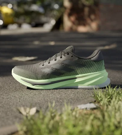 adidas supernova rise black green side view, adidas supernova rise mesh upper close up, adidas dreamstrike cushioning sole detail, adidas supernova rise outsole grip bottom, adidas supernova rise on feet running look, adidas supernova rise heel support design,